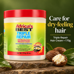 Africa's Best Triple Repair Hair & Scalp Conditioner jar with a red lid and yellow-green label, displayed on a wooden surface with green leaves and shea nuts against a dark green background, with promotional text on the right.
