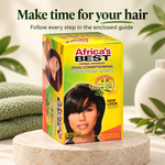 Africa's Best Regular Volume Dual Conditioning No Lye Relaxer System box displayed on a round stone pedestal with a soft-focus background of green leaves and a white vase. Text at the top reads 'Make time for your hair'.
