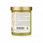Green jar with gold lid and label on a white background