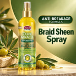 A bottle of African Pride Olive Miracle Braid Sheen Spray stands on a stone surface with olive branches and oil around it. The bottle is yellow with a gold spray top and a green-to-yellow label.