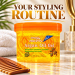 Ampro Pro Styl Argan Oil Gel in a 10 oz jar with an orange lid, set on a marble surface with a wooden comb, white towel, and bathroom background. Large text at the top reads 'YOUR STYLING ROUTINE'.