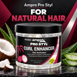 A jar of Ampro Pro Styl Curl Enhancer Gel Activator for natural hair, displayed on a dark reflective surface with coconut, aloe vera, and a bold black and magenta graphic background.