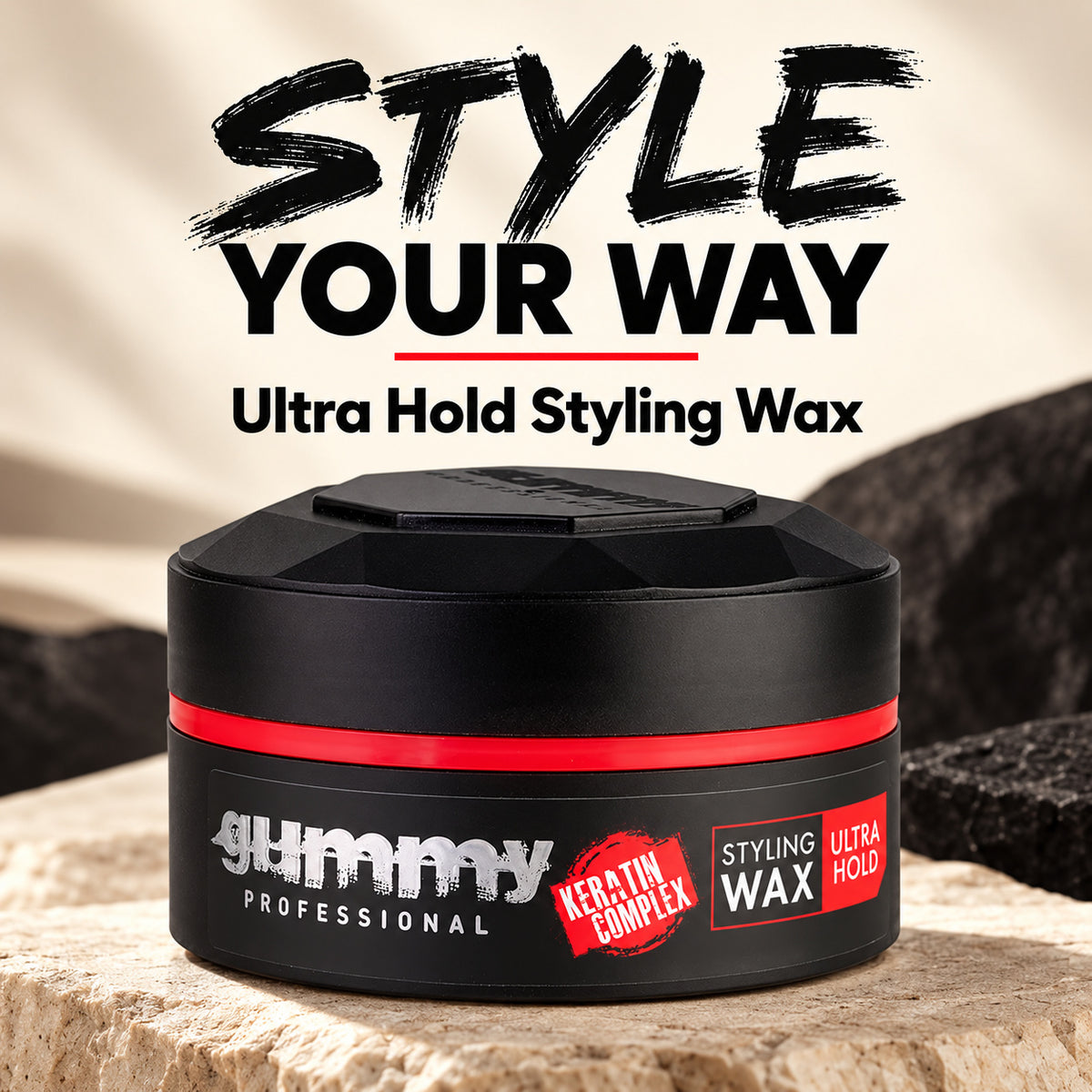 A black jar of Gummy Professional Styling Wax with a red band and white logo, set on a stone surface with a blurred background. Large text above reads 'STYLE YOUR WAY' and 'Ultra Hold Styling Wax'.