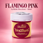 A jar of La Riche Directions hair color in 'Flamingo Pink' against a pink gradient background. The product container has a yellow and maroon label with a white lid, and the text 'FLAMINGO PINK' is written at the top.