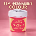 A jar of La Féche Directions semi-permanent conditioning hair colour, shown against a pink background with text reading 'SEMI-PERMANENT COLOUR'. The product container has a white lid and a yellow and pink label.