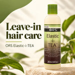 A bottle of ORS Elastic-i-TEA leave-in hair conditioner stands on a stone surface with large green leaves and a soft cream background. The bottle is off-white with a green cap and a green-to-brown label.