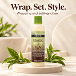 A bottle of ORS Elastic-i TEA Wrapping and Setting Lotion stands on a round stone pedestal with green tea leaves around it. Large text at the top reads 'Wrap.