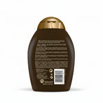 Back of a brown shampoo bottle with gold cap on a white background