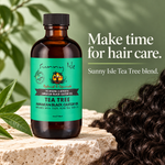 An amber glass bottle of Sunny Isle Tea Tree hair care oil with a bright green label, placed on a stone surface with tea tree leaves and a close-up of dark curly hair in the foreground. Text on the right reads, 'Make time for hair care.