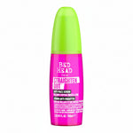 Pink and green serum bottle with 'Bed Head' branding on a white background