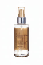 LuxeOil hair oil bottle with gold cap on a white background