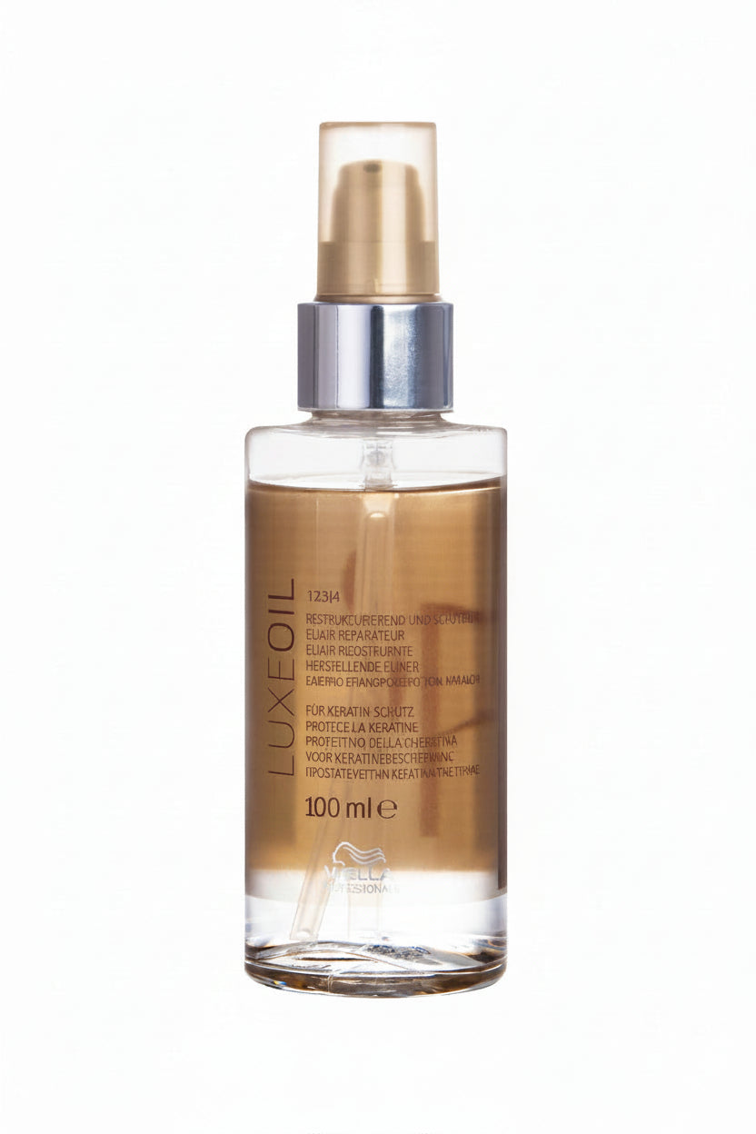 LuxeOil hair oil bottle with gold cap on a white background