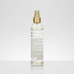 Spray bottle with gold nozzle on a white background