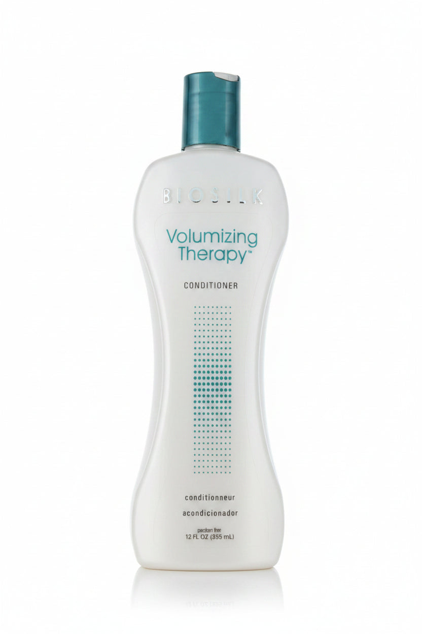 Bottle of Volumizing Therapy conditioner with a blue cap on a white background