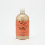 A bottle of Shea Moisture Coconut & Hibiscus Curl & Shine Shampoo, 384ml, with a beige label on a white background.