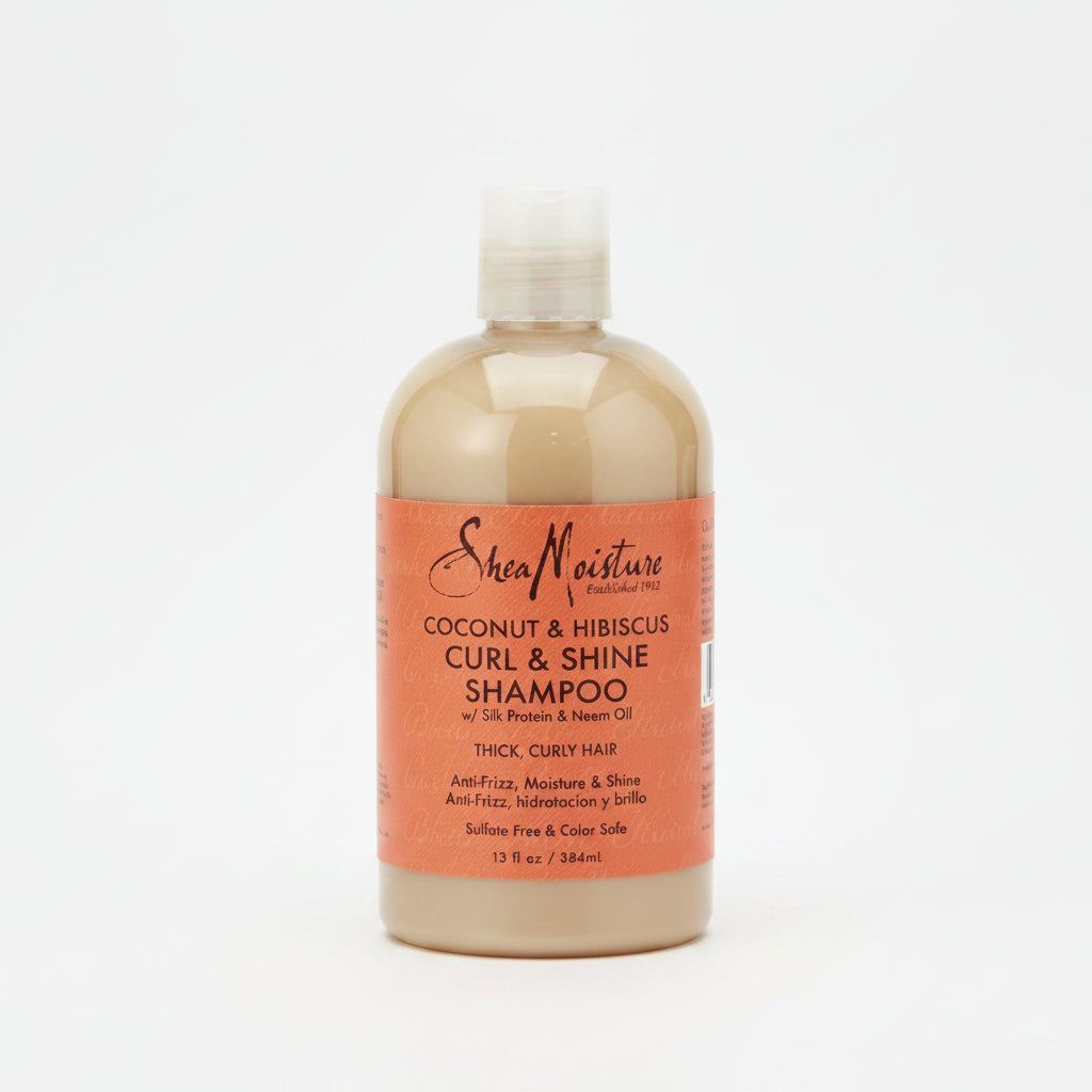 A bottle of Shea Moisture Coconut & Hibiscus Curl & Shine Shampoo, 384ml, with a beige label on a white background.